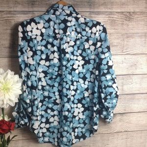 A beautiful Tommy Hilfiger button down blouse, black background, blue floral.